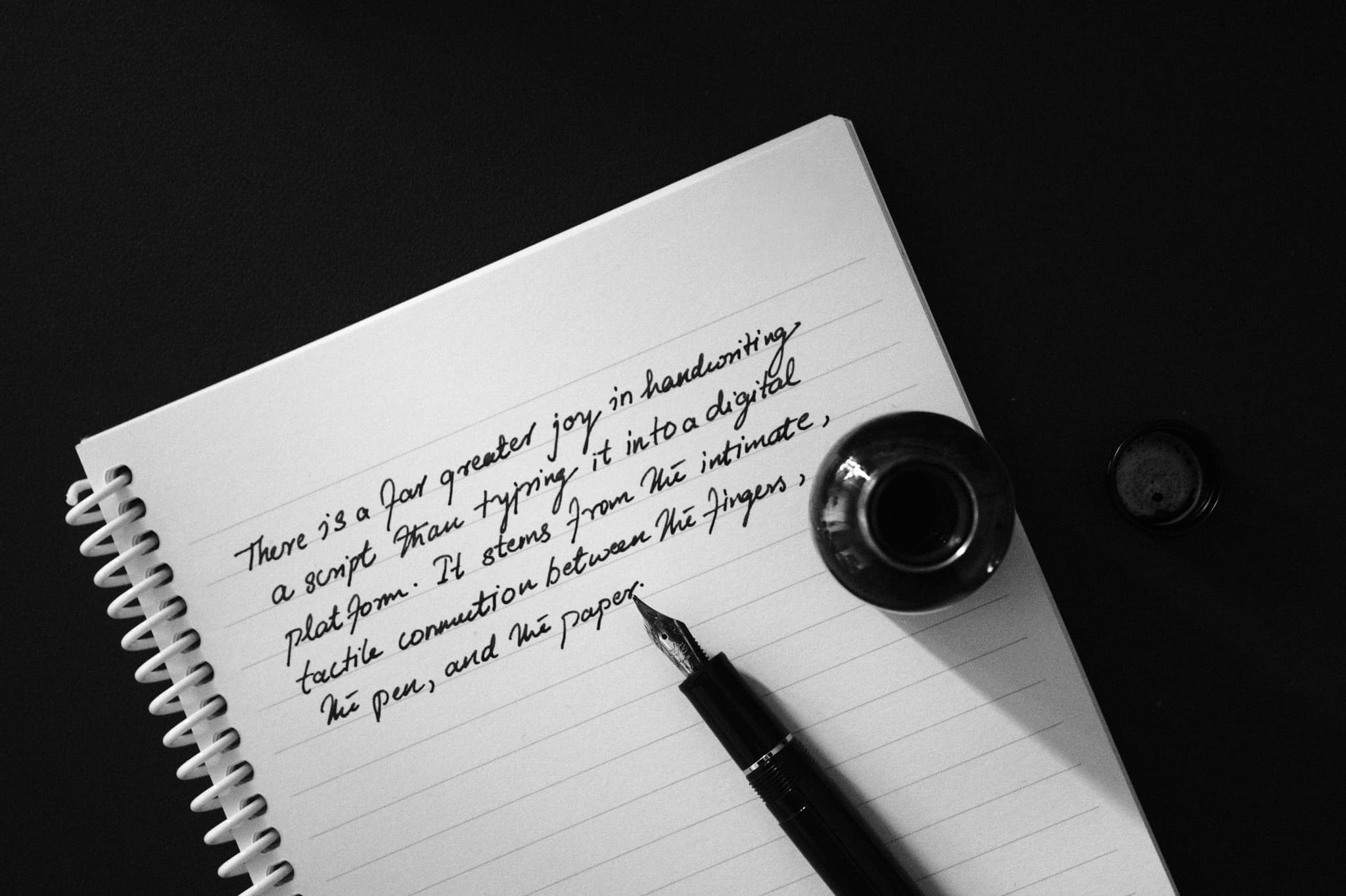 A fountain pen and ink beside handwriting on paper, the craft of the signed record.