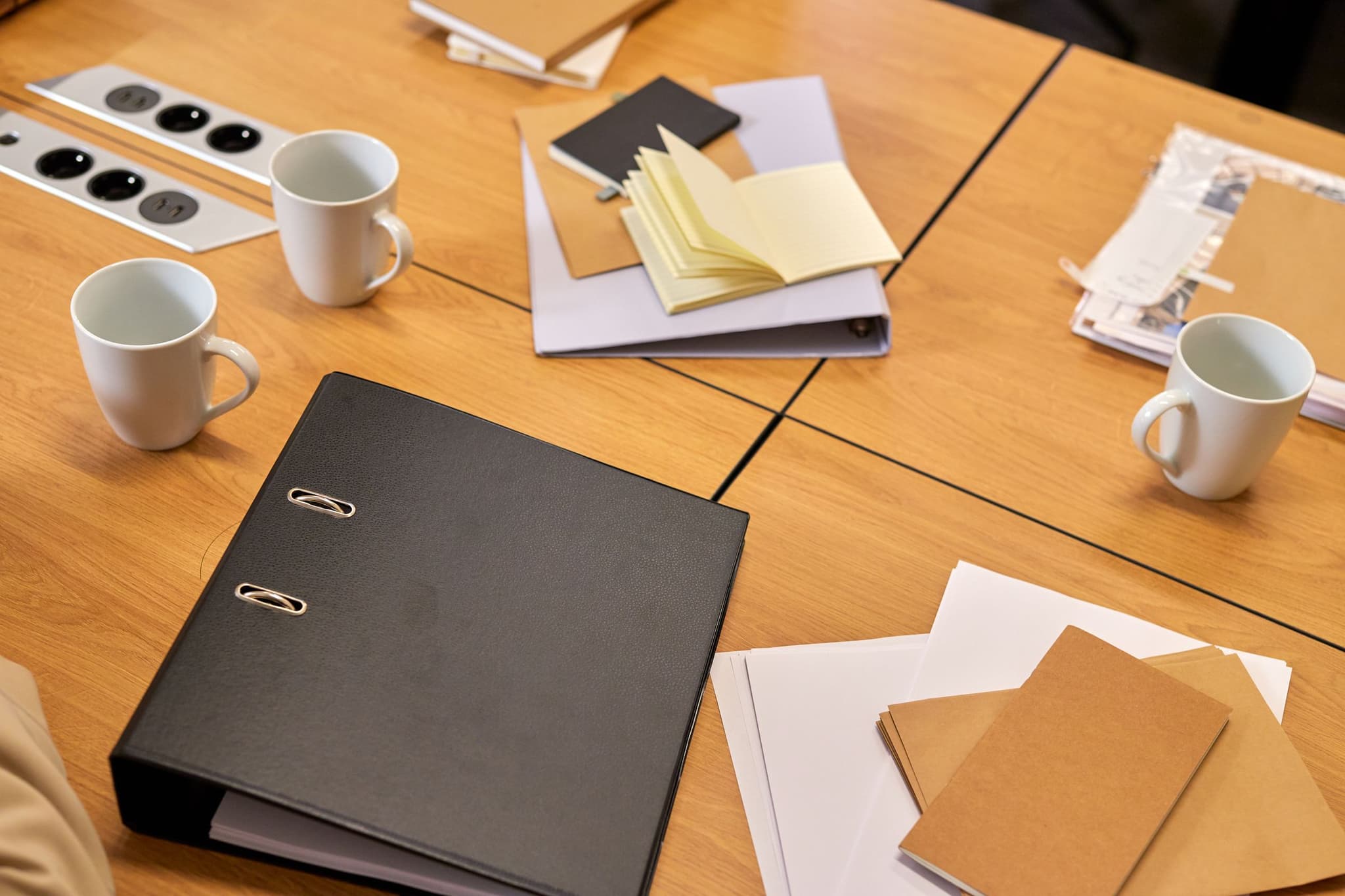 A neat office desk in warm light with folders and papers arranged for the day.
